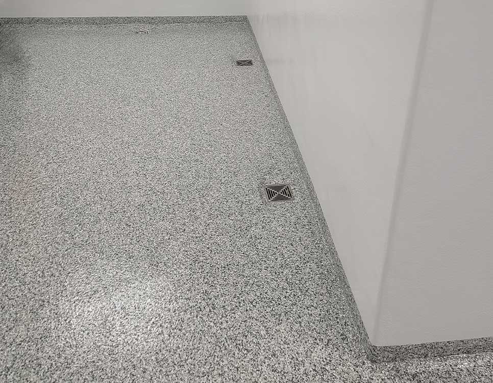 Quartz Coatings and Stranlock Wall Coating Systems shown in a seamless, durable facility space with integrated floor drains and hygienic finishes.